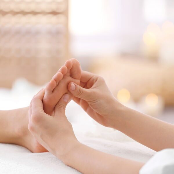 Foot massage in spa salon, closeup